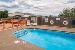 阿拉莫戈多Quality Inn & Suites Near White Sands National Park的木质围栏前的游泳池