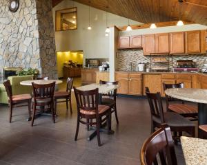 东叙拉古Comfort Inn & Suites Syracuse-Carrier Circle的厨房以及带桌椅的用餐室。