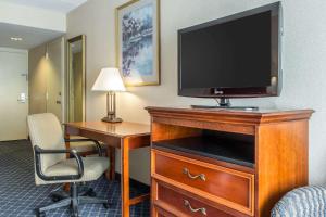 朗康科马克拉丽奥酒店及会议中心的酒店客房的梳妆台配有电视和书桌