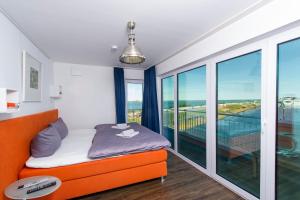 奥尔本尼兹Art Haus的一间带橙色床的卧室和一个阳台