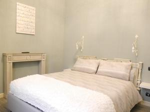 阿尔巴L'Ortodellerose的卧室配有白色的床和桌子