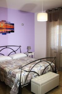 庞贝Dimora Pompeiana的一间卧室配有一张床和紫色的墙壁