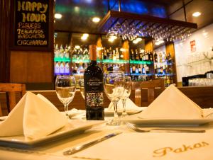 帕卡斯马约El Puerto Hotel的一张桌子,上面放着一瓶葡萄酒和眼镜