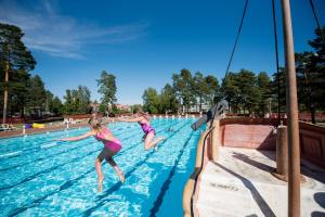 奥萨First Camp Orsa - Dalarna的两个年轻女孩跳进游泳池