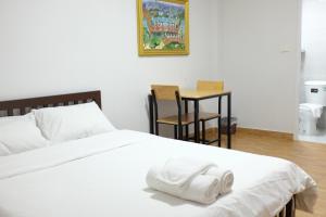 莱卡邦苏瓦纳普米WJ酒店的一张白色的床,上面有一条毛巾