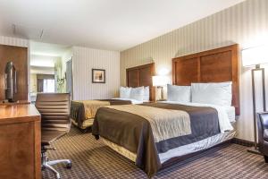 半月湾Quality Inn Half Moon Bay-Miramar Beach的酒店客房配有两张床和一张书桌