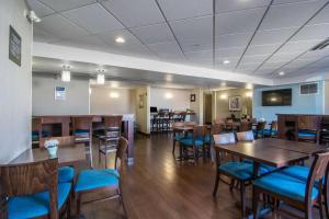 卡尔加里机场南康福特茵套房酒店的用餐室配有木桌和蓝色椅子