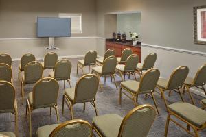 纽黑文纽黑文乡村套房酒店的一个带椅子和投影屏幕的会议室