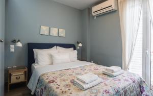 比雷埃夫斯Piraeus Apartment with Endless View的一间卧室配有带毛巾的床