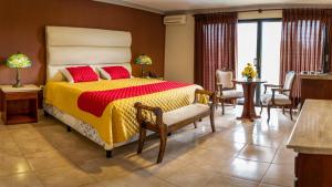 塔里哈洛斯西伯斯酒店的一间卧室配有一张黄色和红色的被子的床