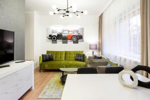 维尔纽斯Luxury for everyone - Hills Park Lux Apartments 2的客厅配有绿色沙发和电视