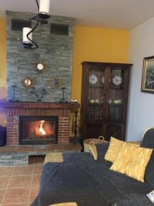 AlmogíaCasa Cuatro Vientos - Barranco Del Sol的客厅设有壁炉和沙发。