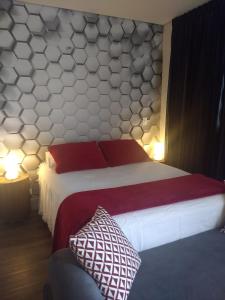 圣保罗Studios Centro SP 16的一间卧室配有一张带红色和白色枕头的大床