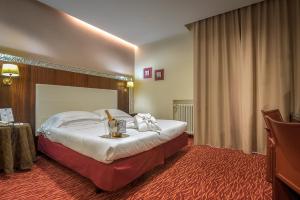 博洛尼亚马焦雷酒店 的一间酒店客房,配有一张床铺和一张桌子