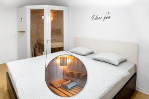 萨格勒布Sauna - Flexible SelfCheckIns 6 - Zagreb - Garage - Electric vehicle ccharger - Loggia - New - Luxury - Apartments Repinc 6的一间卧室配有一张带圆镜子的床