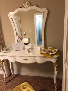 Castel BaroniaB&B Baronia Luxury Rooms的墙上的白色梳妆台和镜子