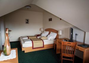 勒什图利潘宾馆的一间卧室配有一张床和一张书桌及电视
