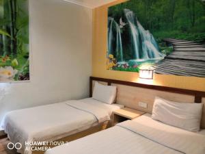古晋兆丰旅馆的两张床位于带瀑布壁画的客房内。