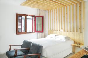 加亚新城7 Gaia Roaster Apartments的卧室配有白色的床和2把椅子