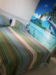 里约热内卢Barra da Tijuca Resort Bora Bora的一间卧室配有一张带海滩绘画的床