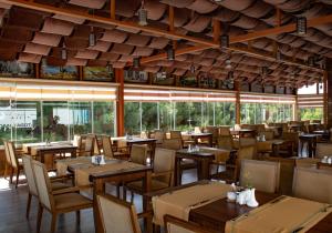 巴库欧洲大酒店 的餐厅设有木桌、椅子和窗户。