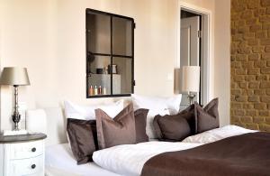新策勒新策勒修道院酒店的一间卧室配有带枕头和镜子的床