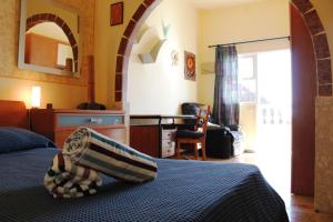 FasniaCALETA LOS ROQUES的一间卧室配有一张床、一张桌子和一把椅子