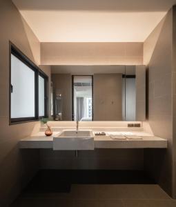 曼谷T2 Residence Sathorn的一间带水槽和大镜子的浴室