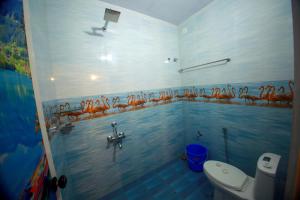 阿勒皮MARARI GOD's OWN VILLA的一间带卫生间的浴室,墙上绘有动物。