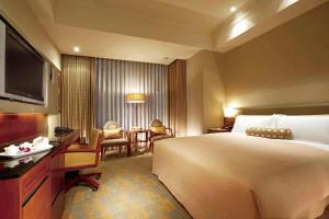 台北神旺商务酒店的酒店客房设有一张大床和一张书桌。
