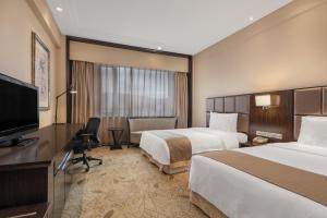 牡丹江牡丹江世茂假日酒店的酒店客房设有两张床和一台平面电视。