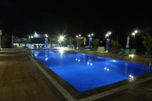MundraThe Fern Residency Mundra的夜间游泳池,拥有蓝色照明