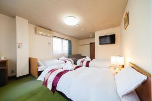 白马村P-鲍贝提酒店的酒店客房,设有四张床和一张沙发