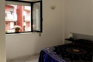 加利波利Residence Lido San Giovanni Baia Blu By Nonsolomare Case Vacanze srlu的一间卧室设有一张床和一个窗口