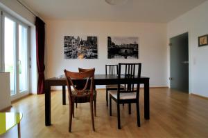 维尔茨堡Luxury city apartment - view of river and castle的一间用餐室,配有黑色的桌子和椅子