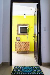 La ChumicosaSun n' Sand Retreat的一间设有黄色墙壁和一面镜子的门的房间
