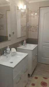 ÁsványráróÁsványráró Apartman House的白色的浴室设有两个盥洗盆和镜子