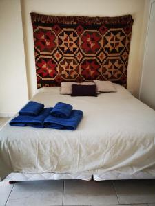 General SarmientoApartamentos Itati的床上有2个蓝色枕头