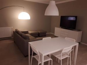 克拉科夫Wielicka Apartment 2的客厅配有白色的桌子和椅子