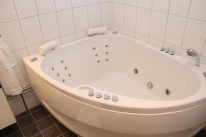 林德斯贝里林德斯贝里城镇酒店的浴室内设有大型白色浴缸。