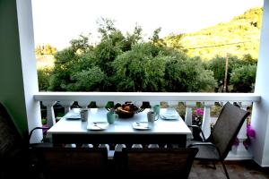 凯里翁Mersina Apartments的阳台上的餐桌上放着一碗食物