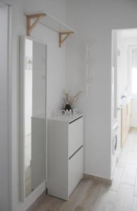 布达佩斯White Almond Apartment的白色的厨房配有梳妆台和镜子