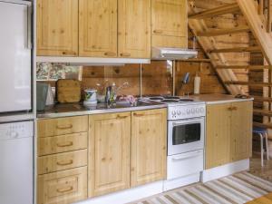 拉赫登佩拉Holiday Home Juvan-vuokko by Interhome的厨房配有木制橱柜和炉灶。