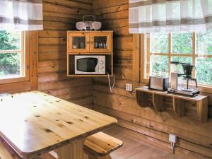 拉赫登佩拉Holiday Home Juvan-vuokko by Interhome的木房间设有桌子和微波炉
