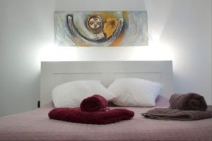 巴塞罗那萨格里拉公寓的一间卧室配有带枕头的床铺和绘画