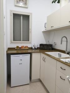 Beʼer Oraסויטה בלב המדבר.的白色的厨房配有水槽和洗碗机