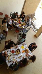 土巴迪亚劳Ker Lep Jamm - Chez Moussa et Cinzia的一群人坐在桌子旁吃着食物