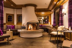 采尔马特Hotel Bella Vista Zermatt的一间带壁炉的餐厅,位于客房中间