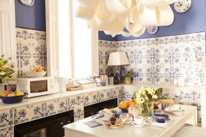 巴塞罗那Close to Passeig de Gracia的厨房配有蓝色和白色的壁纸以及一张带食物的桌子
