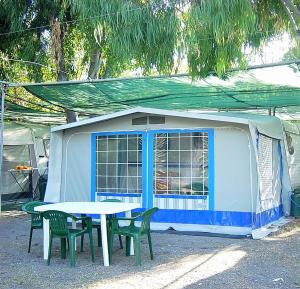 马拉泰亚Villaggio Camping Maratea的蓝白色帐篷,配有桌椅